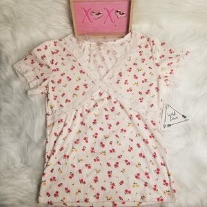 This cute cream summer shirt with floral print  and lace around the sleeves